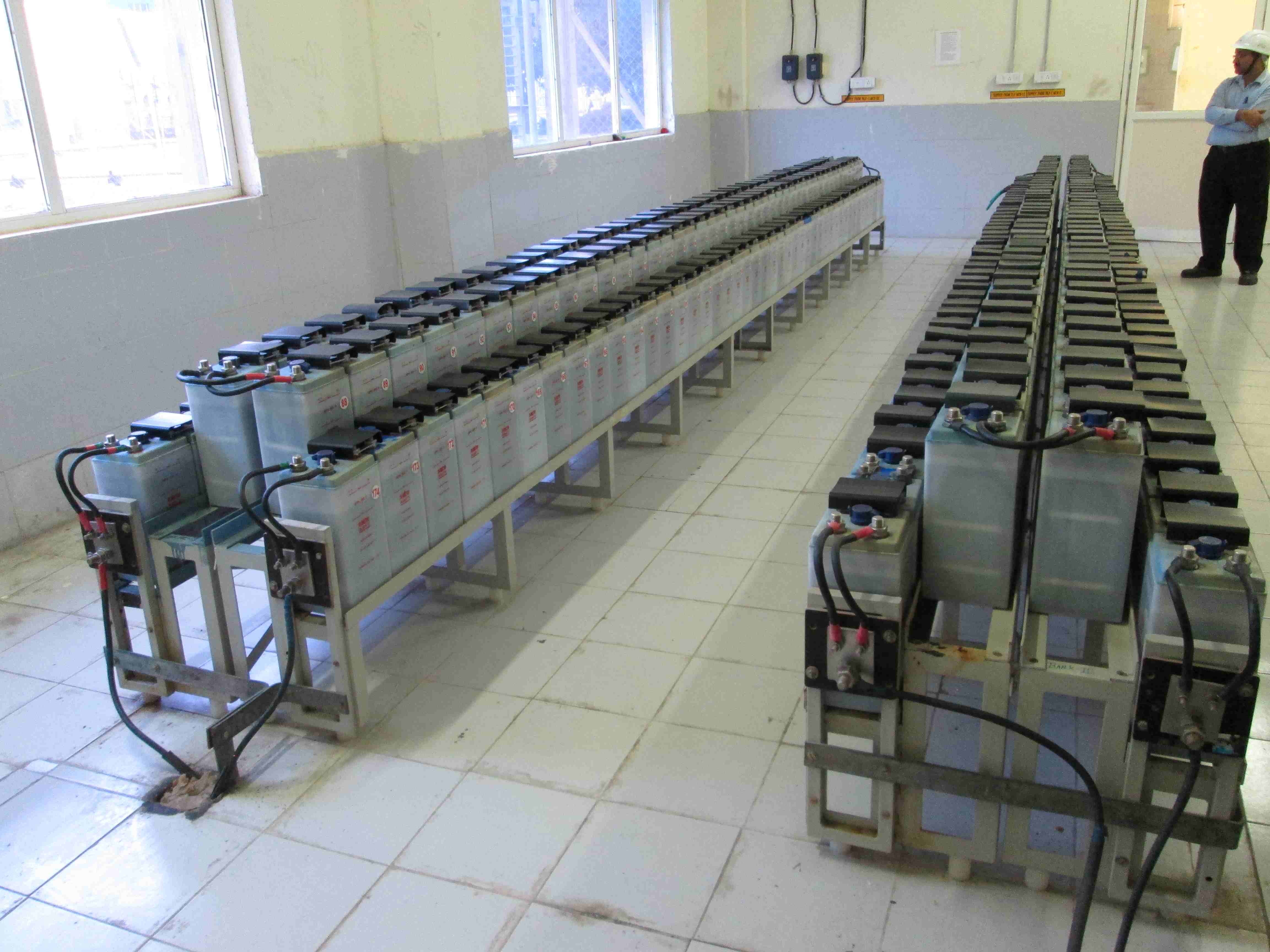 Comprehensive view of a battery bank room featuring rows of energy storage units connected to ensure uninterrupted power supply for plant operations.
