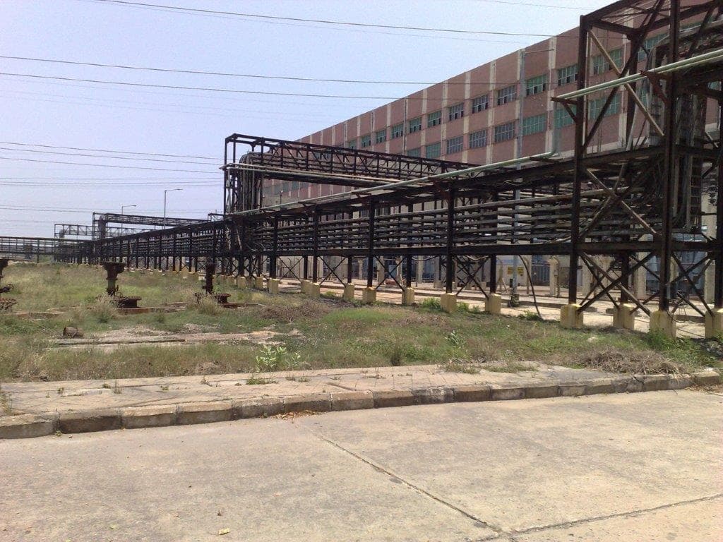 Primary cable rack system implementation showing organized routing of multiple cable bundles in an industrial corridor.