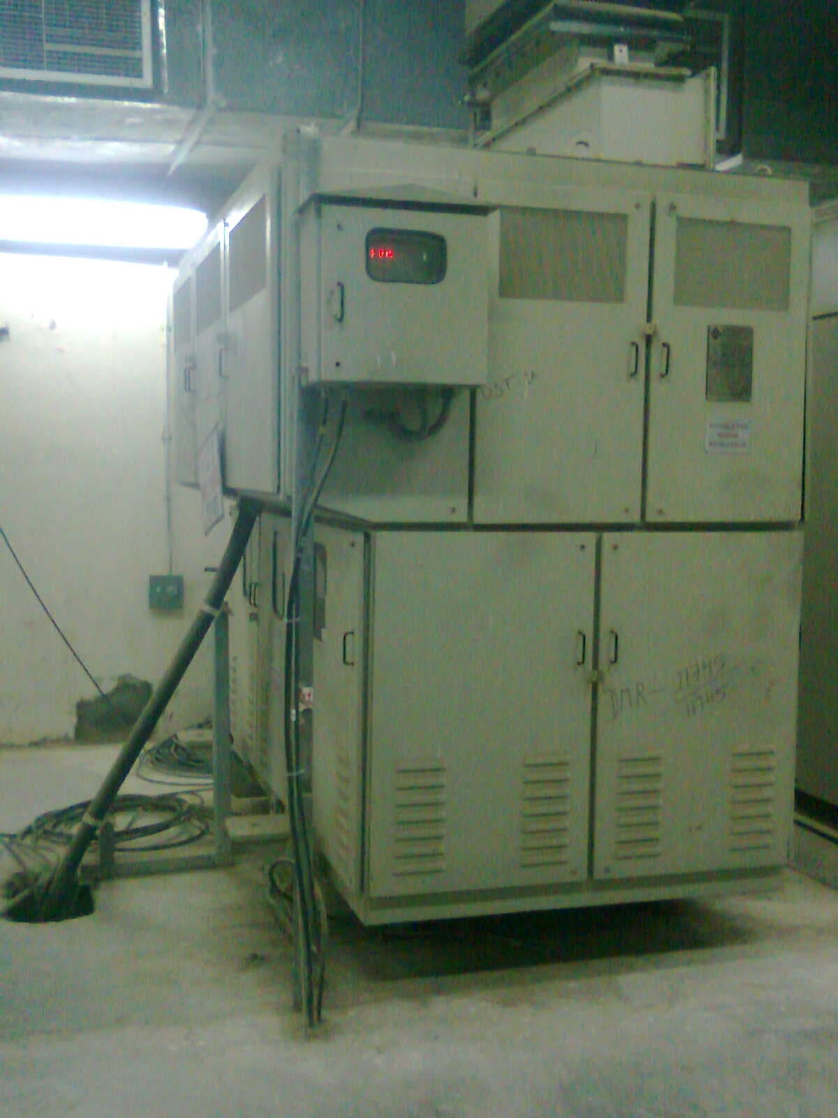 Stand-alone outdoor transformer installation on a concrete plinth, complete with oil containment and safety fencing.