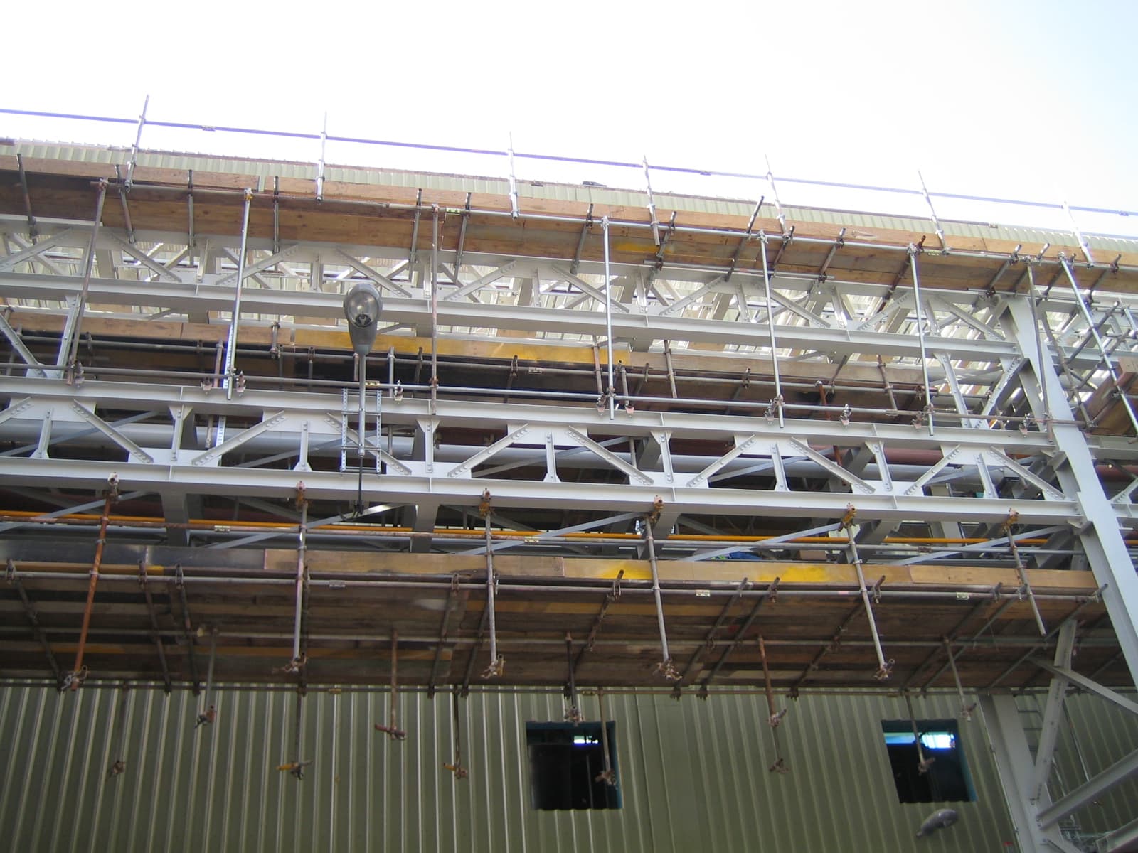 Industrial facility rooftop view showing HVAC units, cable tray runs, and lightning protection grid.