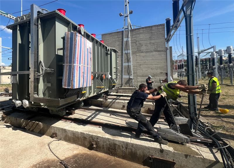 Complex transformer handling operation involving heavy-lift cranes and specialized transport trailers.