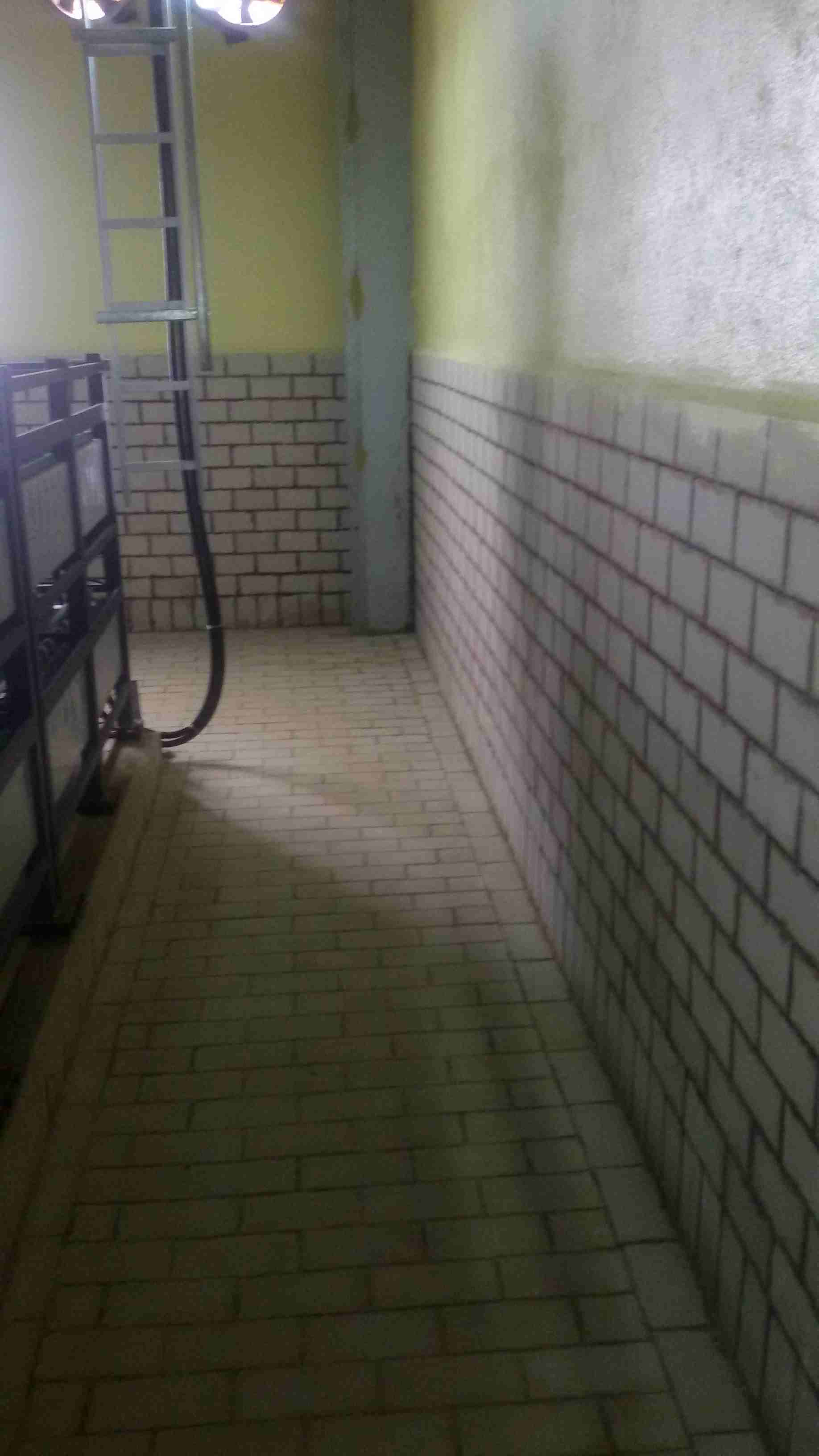 Detailed view of a concrete cable trench area prepared for underground power distribution, featuring structured routing paths for high-voltage and control cables.