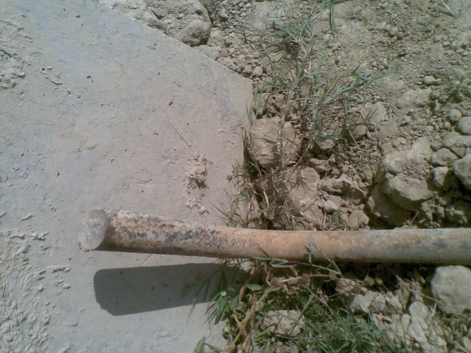 Copper-bonded earth rod installation detail, driven deep into the soil to reach low-resistivity strata for effective grounding.