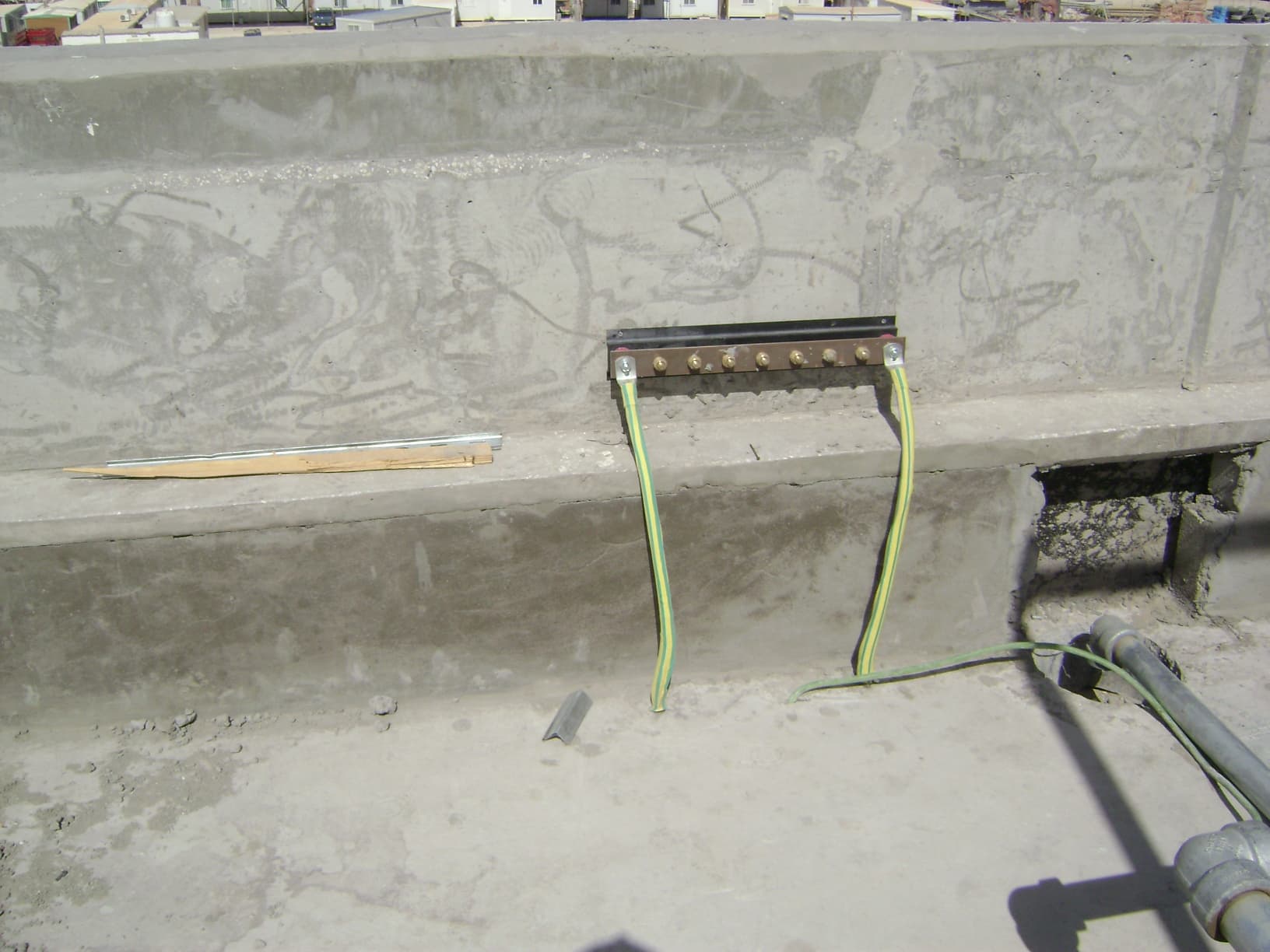 Copper earthing busbar installation providing a common grounding point for multiple electrical circuits and equipment frames.