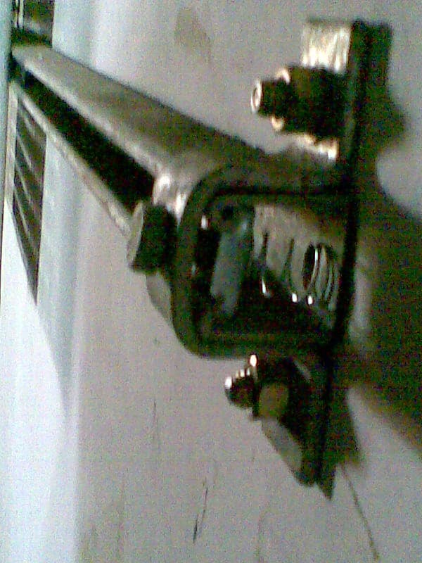 Standard GI pipe support clamp assembly demonstrating a secure fastening method for piping runs along walls or ceilings.