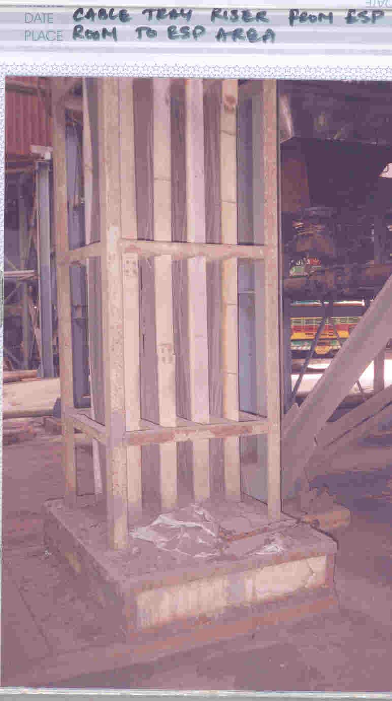 Major outdoor pipe rack artery carrying process piping and cable trays between different plant units.