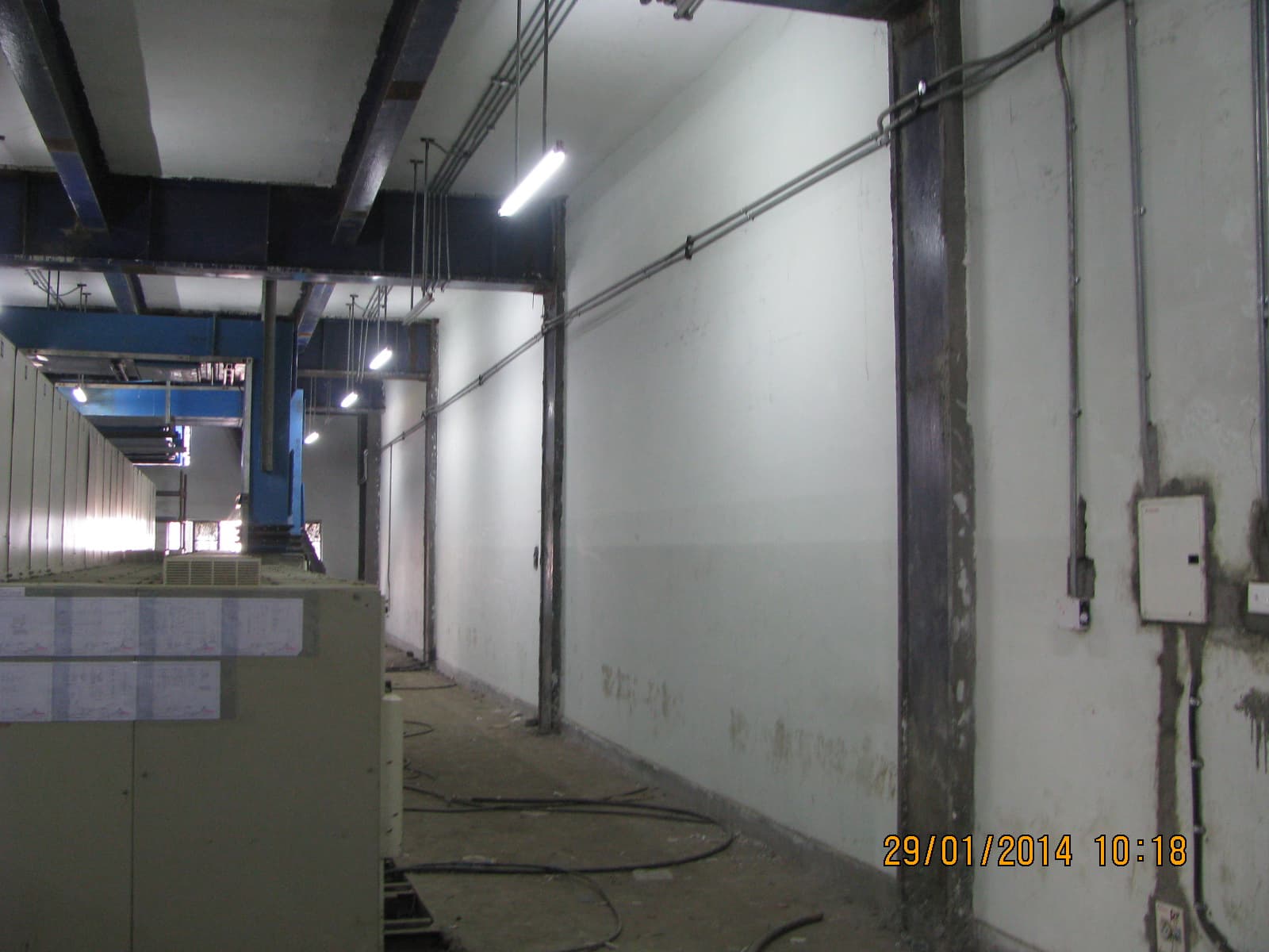 Designated material storage area with organized racking for electrical spares and construction materials.